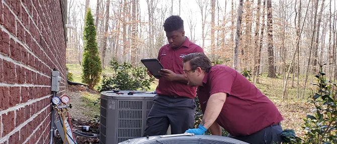 Two techs installing a new unit