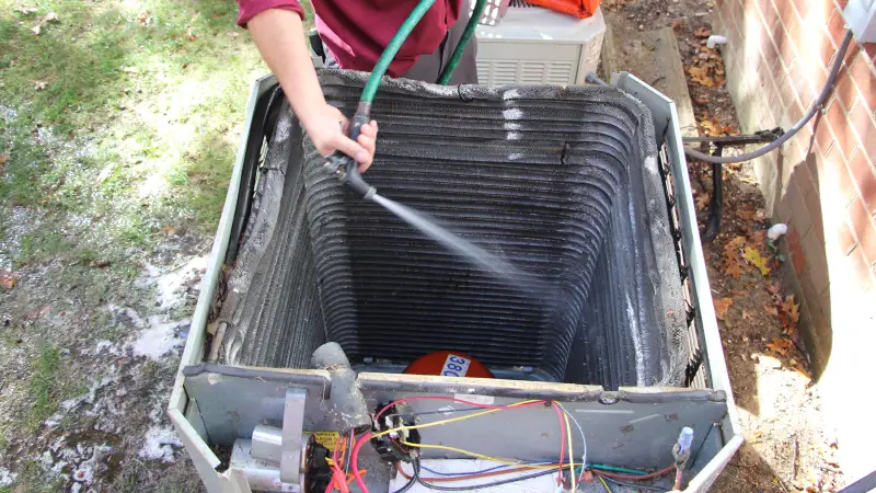 Technician cleaning AC