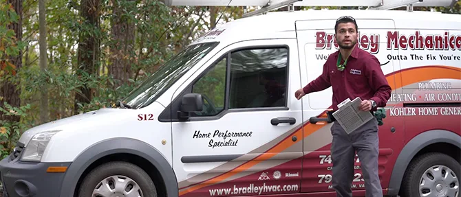 Technician standing beside a branded service van.