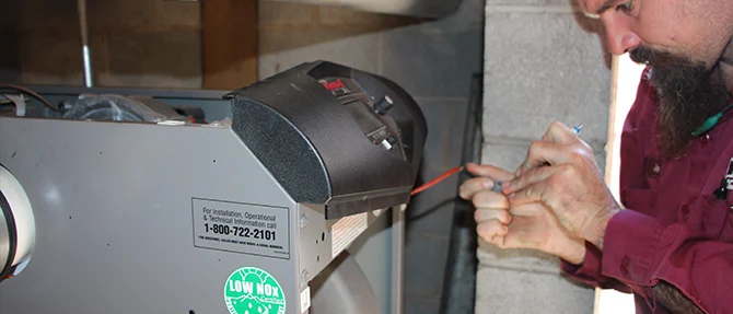 Technician adjusting boiler controls during professional maintenance service