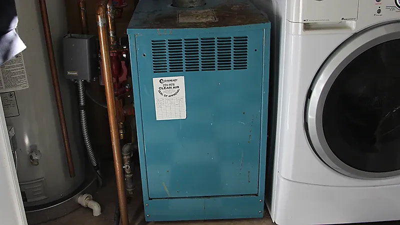 Residential furnace installed in laundry room next to washer