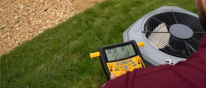 Technician measuring HVAC system performance.