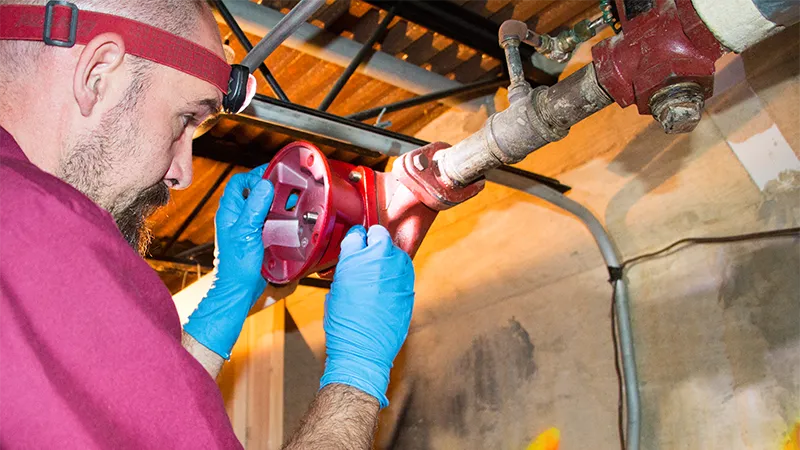 Technician working on pipes