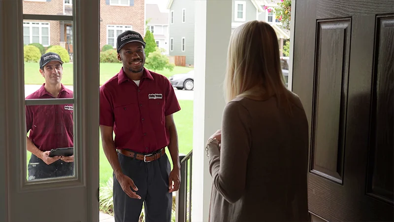BM technicians meeting a homeowner at the front door.